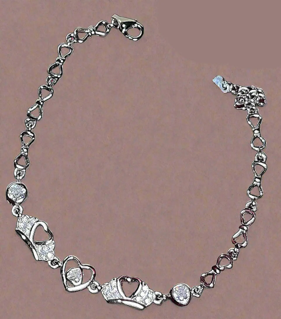 Silver bracelet with heart-shaped links on a brown background